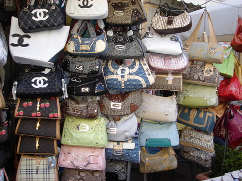 Fake luxury purses are sold on a sidewalk in downtown Guiyang, the capital  of China's Guizhou